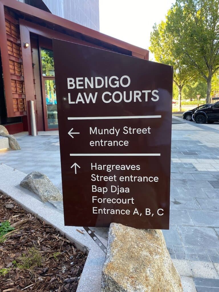 A sign showing directions to enter Bendigo Magistrates Court - Shamac Lawyers