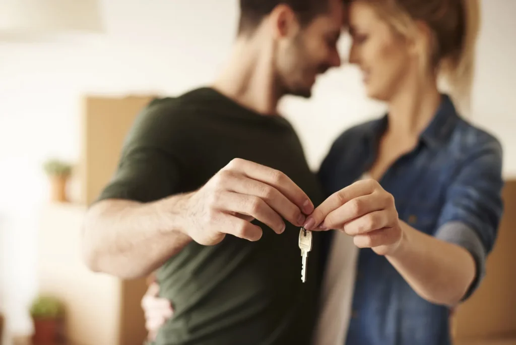 Couple holding the keys to their new home after settlement with Shamac Lawyers’ Melbourne conveyancing team
